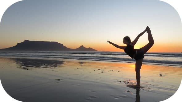 Yoga pose on the beach at sunset in Bali